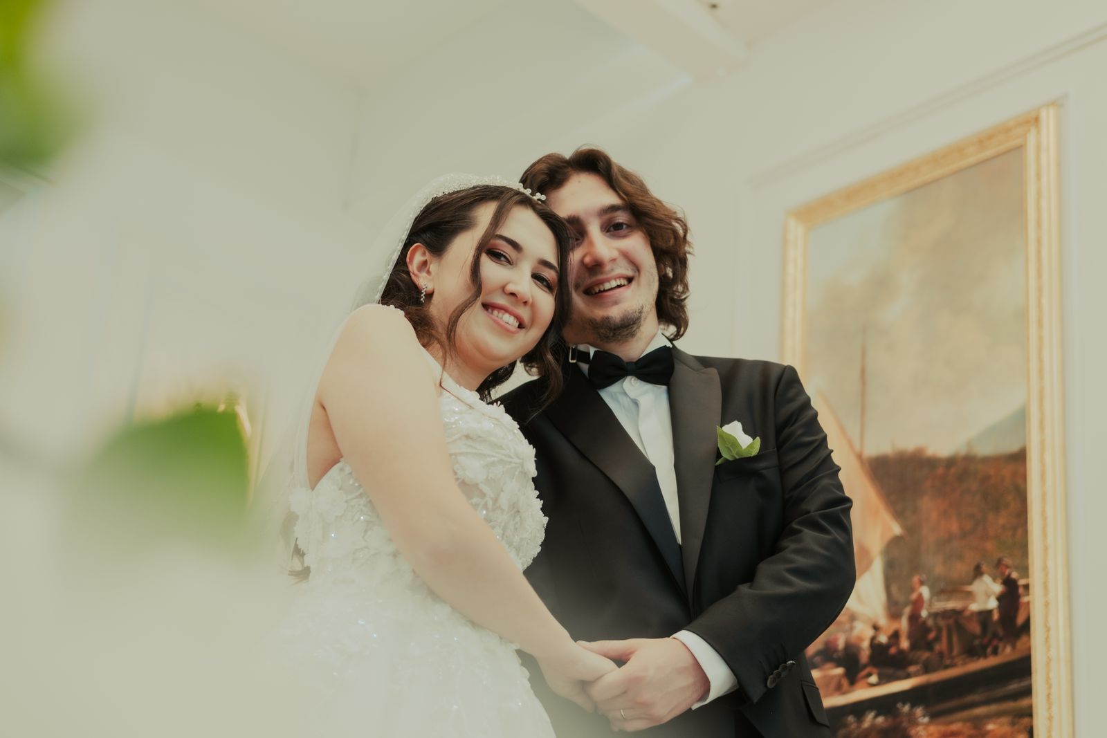 Happy bride and groom posing together in a warm wedding portrait