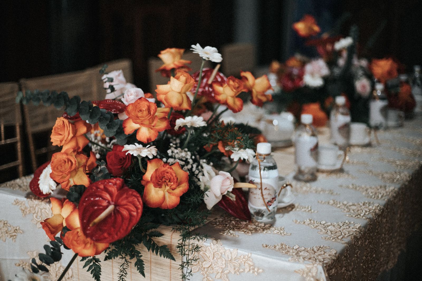 Wedding reception table styled with fresh floral centerpieces and fine place settings