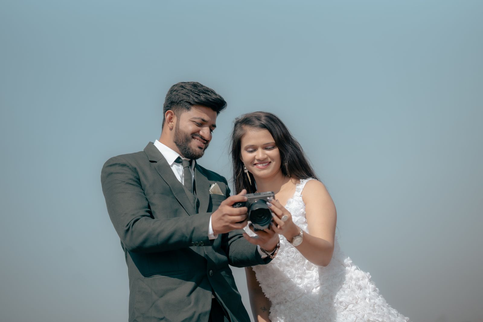 Candid moment of a wedding couple laughing together outdoors